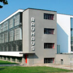 Edificio de la escuela Bauhaus en Dessau, ejemplo de arquitectura moderna con líneas rectas, grandes ventanales y diseño funcional.