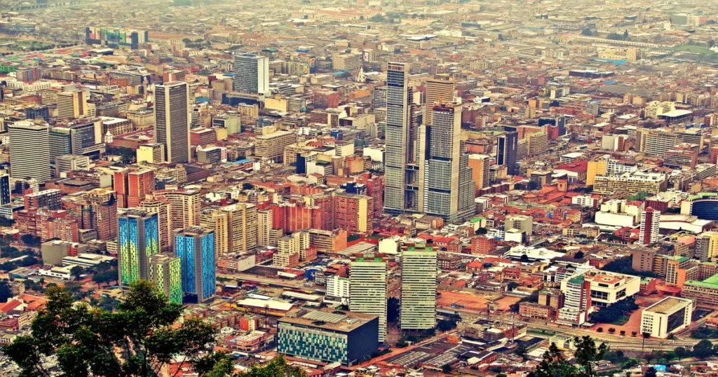 vista aérea de Bogotá 24 horas 2026 con rascacielos, edificios iluminados y desarrollo urbano contemporáneo